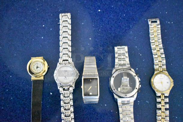 Four assorted watches and a watch band, mixed brands and styles, featuring metal and leather straps. Some visible brand markings.