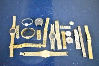 48 assorted watches and bands on a blue surface, featuring various styles and metals, ideal for collectors or resellers.