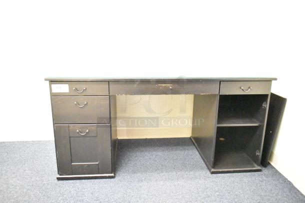 Wooden desk with five drawers, dark finish, visible wear. Features a side cabinet with shelves. Label reads "160".