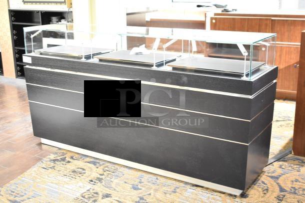 Sleek jewelry case with glass top, featuring six rear drawers. Branding removed. Buyer needs tools for removal.