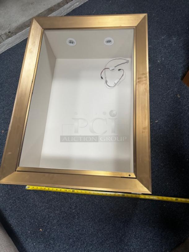 Wall pop out display case with gold trim and interior lighting, measuring approximately 42 inches. Mint condition.