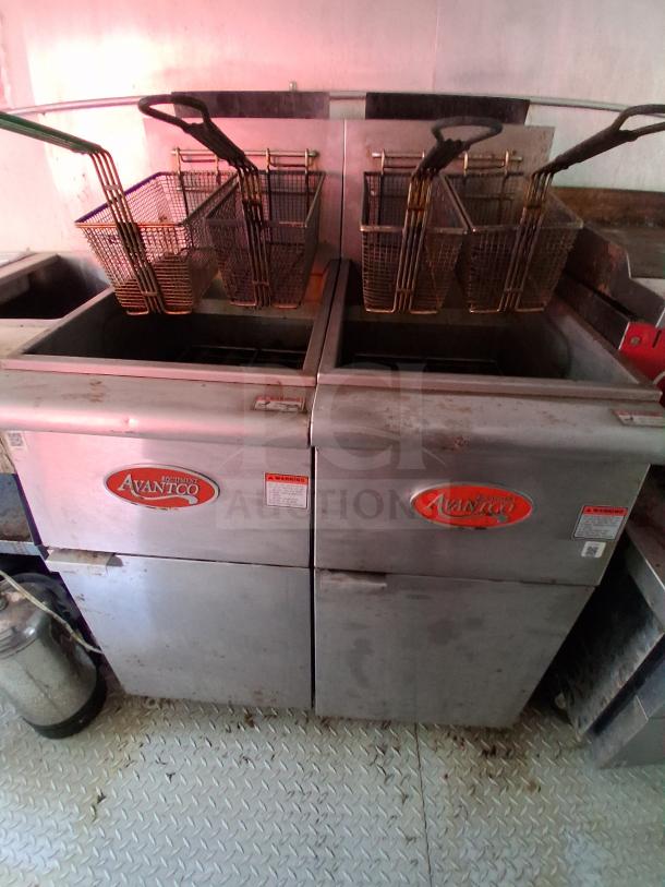 Avantco gas fryer in food trailer, featuring dual frying baskets and stainless steel surface. Used condition.