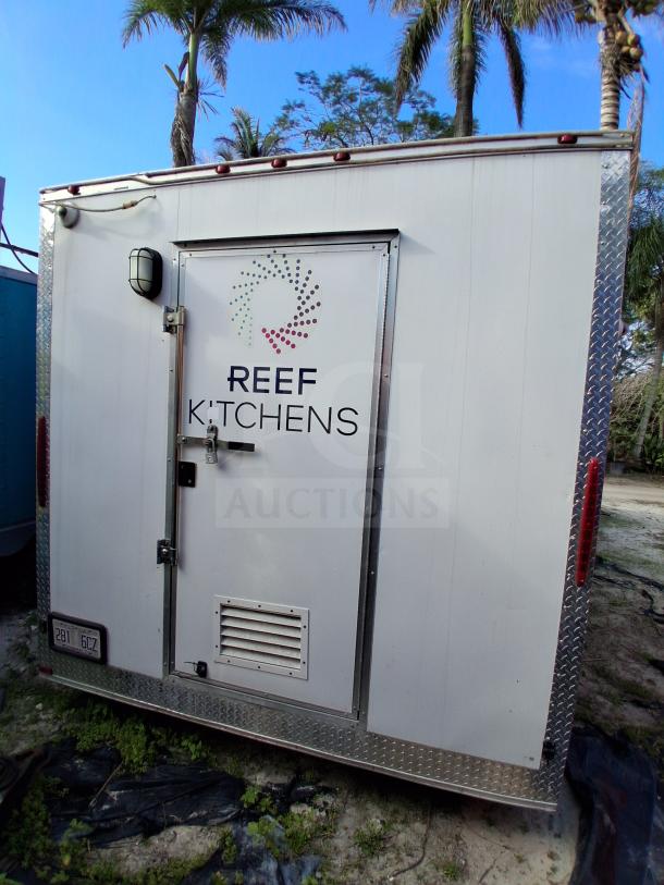 Food trailer with grease hood, Royal Range, Avantco griddle, gas fryer, four-unit fridge package and "Reef Kitchens" logo.