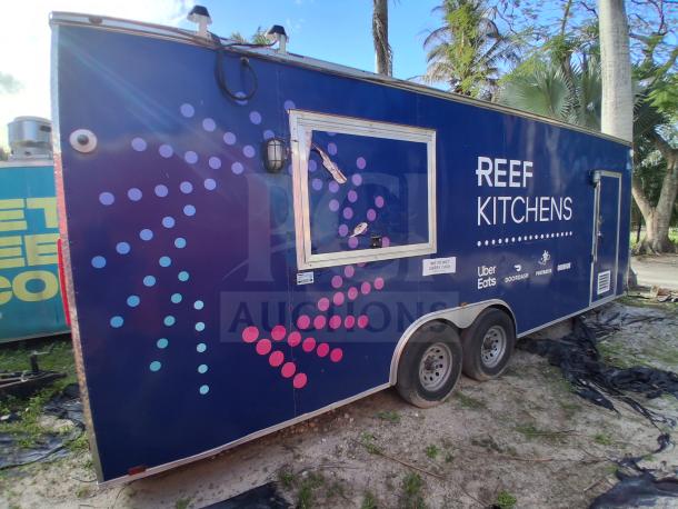 Food trailer with grease hood, Royal Range, Avantco griddle and gas fryer, four-unit refrigeration. Blue exterior with logos.