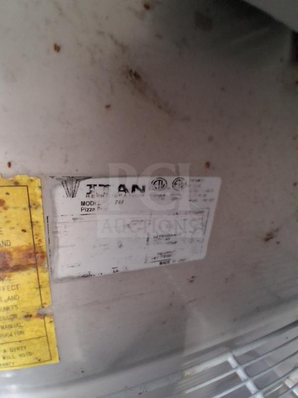Label on equipment shows "Titan Model 747 Pizza Prep." Slight wear and markings visible.