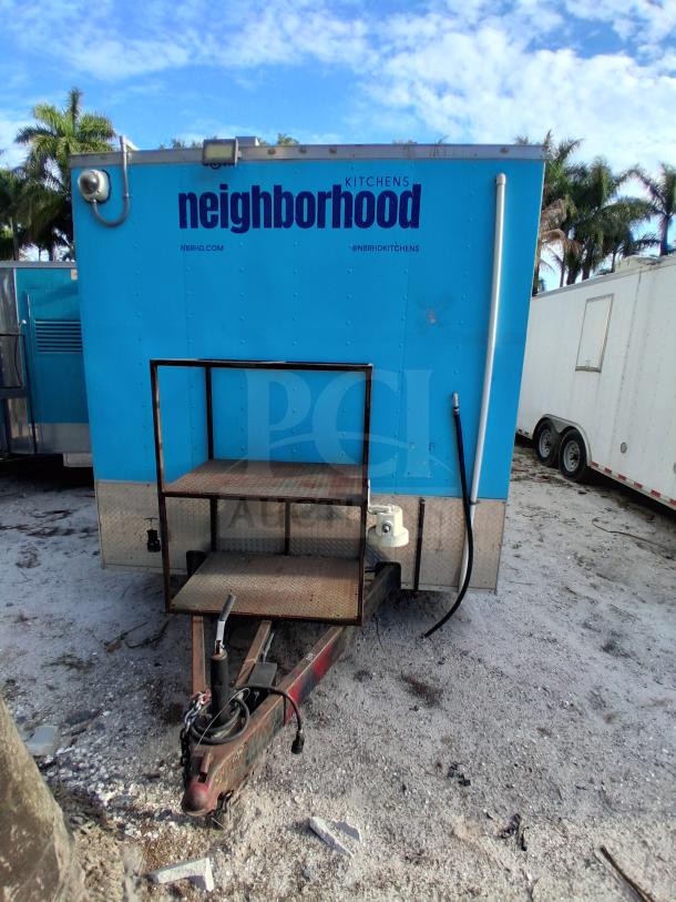 Blue commercial kitchen trailer featuring grease hood, Dean fryers, Sierra griddle, Wells 4-burner cooktop, and Arctic Air refrigeration.