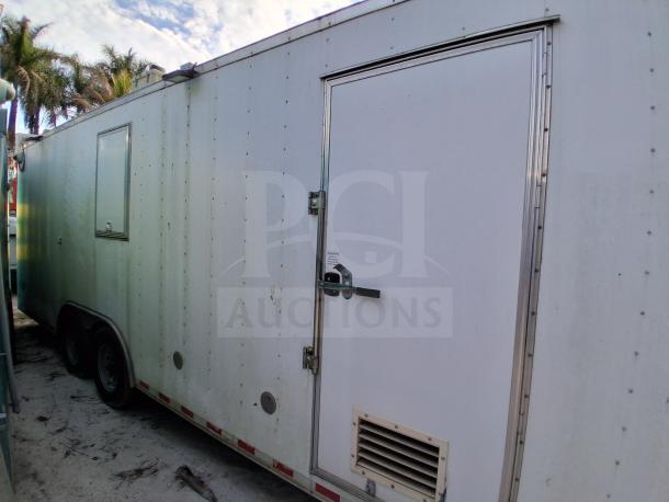 Commercial kitchen trailer, white exterior. Features Dean fryers, Sierra griddle, Wells cooktop, Arctic Air refrigeration. Good condition.
