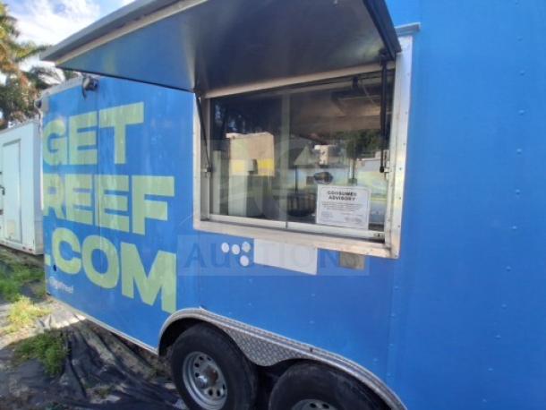 Commercial kitchen trailer with large order window, equipped with grease hood, dual fryers, griddle, burner cooktop, and refrigeration suite.