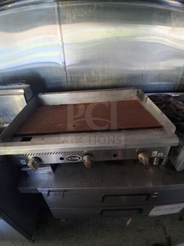 Commercial kitchen trailer featuring a Royal griddle, dual fryers, burner cooktop, and comprehensive refrigeration setup.