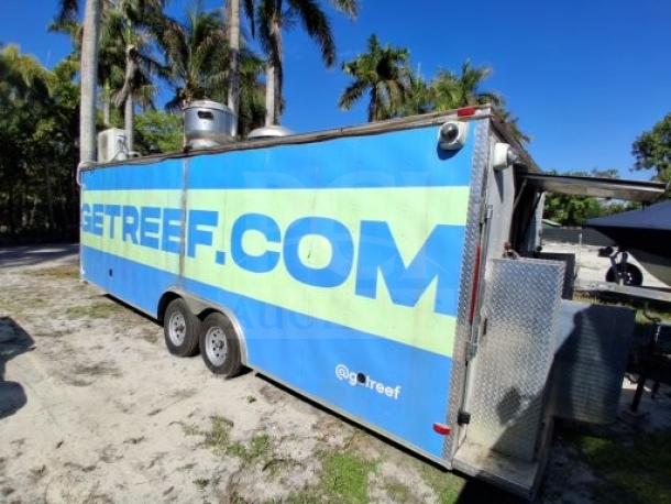 Food trailer with blue exterior, equipped with commercial kitchen appliances. Features robust utility systems and safety measures.