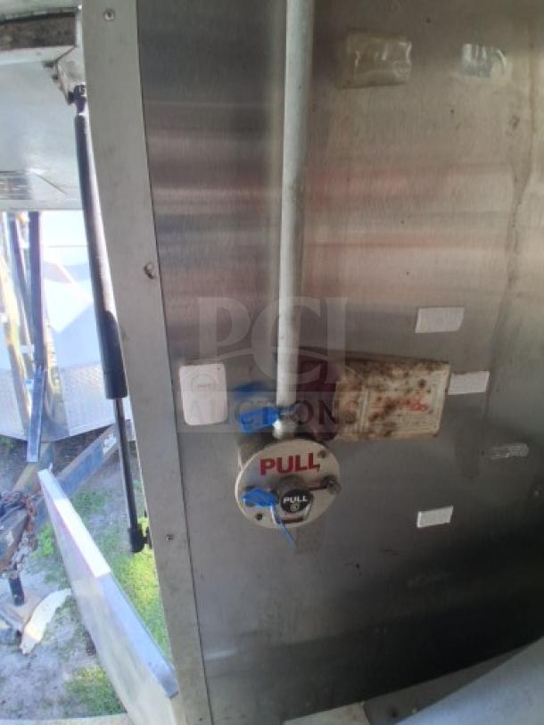 Food trailer interior showing utility systems and safety features, including a pull alarm and wiring. Robust, needs minor improvements.