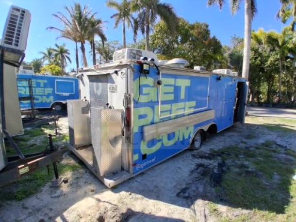 Food trailer with professional-grade kitchen, blue exterior, safety systems, needs improvements, suitable for catering/events.