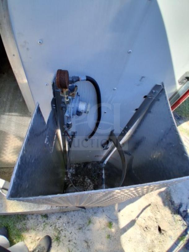 Food trailer utility compartment showcasing its gas regulator and connection setup, indicating outdoor use readiness.