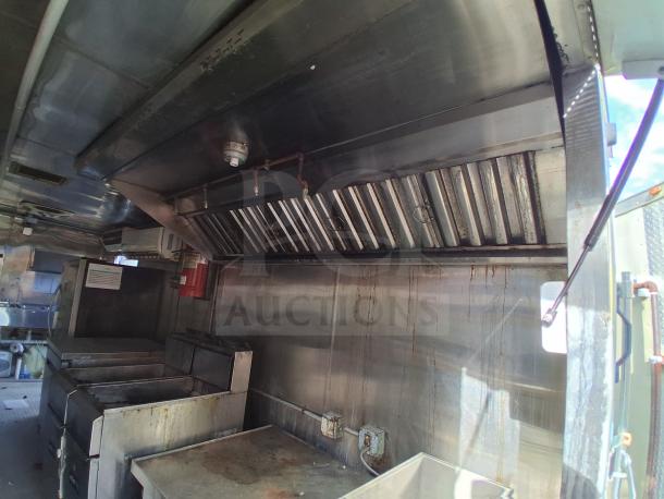 Professional mobile kitchen trailer, featuring commercial refrigeration, fire suppression, and climate control. Model F106.