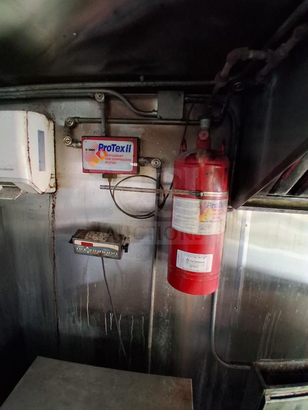 ProTex II fire suppression system in mobile kitchen trailer, featuring commercial refrigeration and climate control systems.