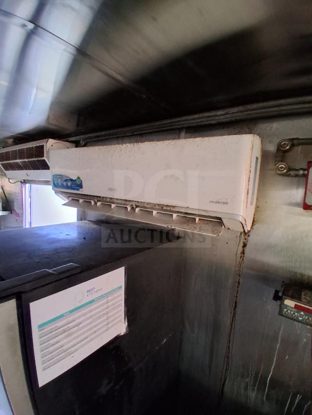 Mobile kitchen interior showing climate control unit and commercial equipment, with visible "Reef Kitchens" label.