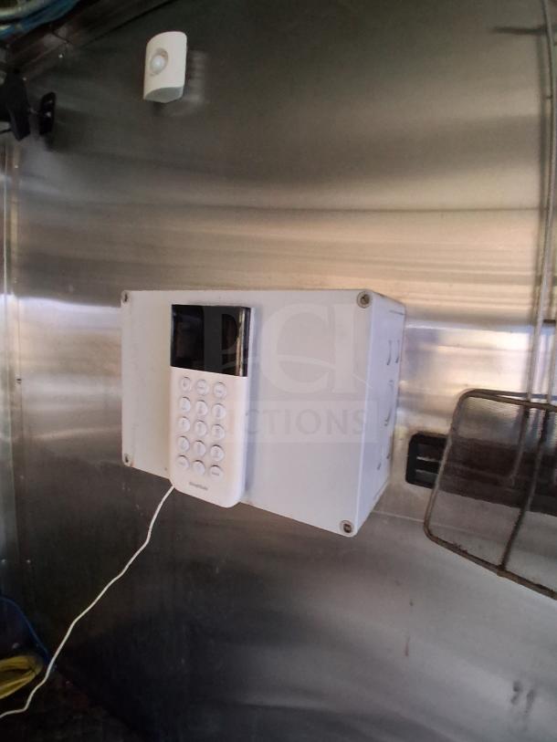 Alt text: "Interior of fully loaded mobile kitchen with keypad, premium appliances, fire suppression, and climate control system."