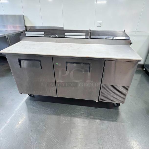 Outstanding condition True TPP-AT-67-HC pizza prep table with marble top, two-door refrigerated base, 115V, fully tested.