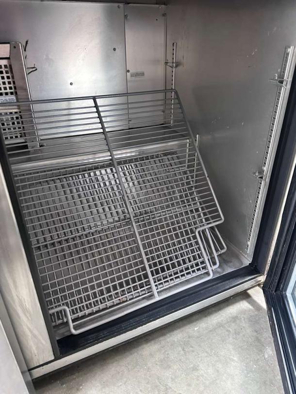True TUC-48G-HC undercounter refrigerator interior with shelves, stainless steel, glass doors, excellent condition.