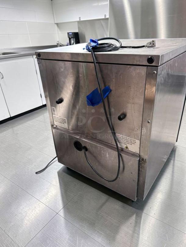 Stainless steel True TUC-27G-HC undercounter refrigerator with glass door, showing rear view. Excellent condition, fully tested.