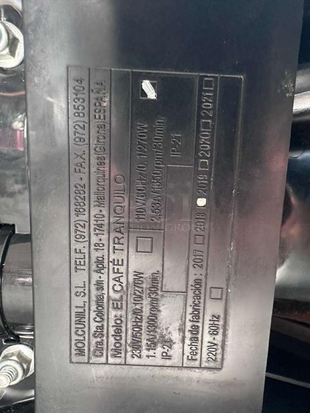 Alt text:  
Label on Cunill Tranquilo-Tron espresso grinder, showing model, voltage, power, and manufacturing info from Spain.