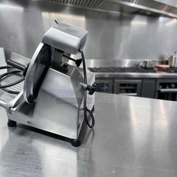 Globe C10 Chefmate manual meat slicer with 10" blade, stainless steel, belt driven, 1/4 HP, excellent condition.