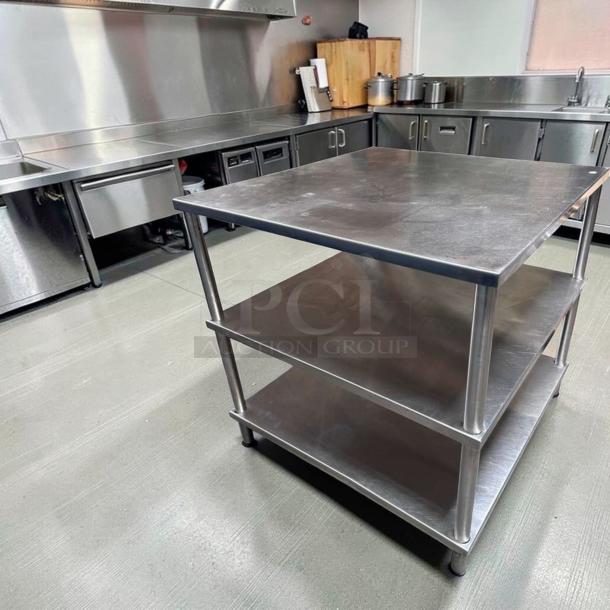 Stainless steel 34" x 34" commercial work table with double shelves, heavy-duty design, superior condition, ready for use.