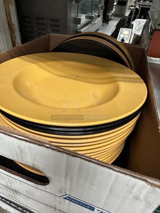 Assorted commercial melamine plates lot, approx. 30 pieces. Yellow and black, heavy duty, excellent condition, foodservice quality.