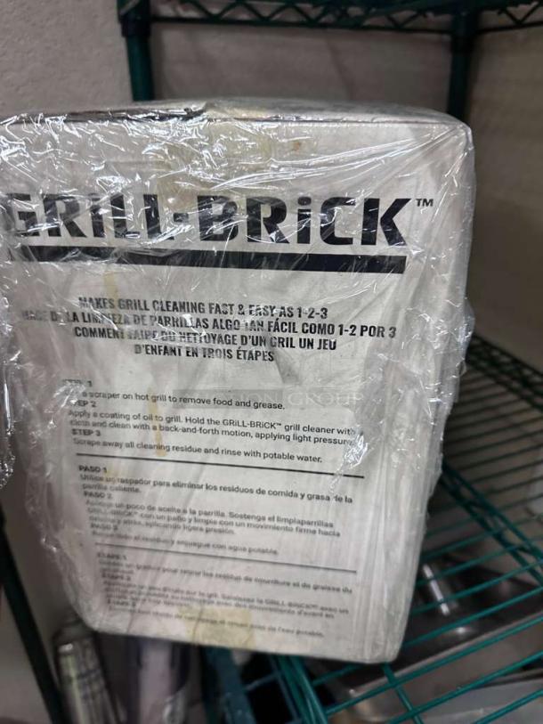 Brand new Grill Brick cleaning block, 8"x4"x3.5", in packaging. NSF certified, removes grease and residue, heavy-duty cleaner.
