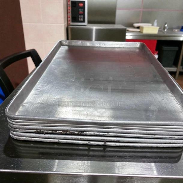 Seven Winco ALXP-1826 full-size sheet pans, 26"x18", 18-gauge aluminum, heavy-duty, in outstanding condition.