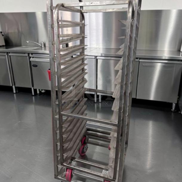 Commercial stainless steel bun pan rack, mobile, heavy-duty, superior condition, fully tested, red wheels, kitchen setting.