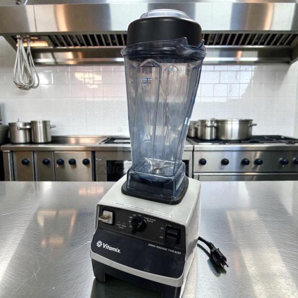 Vitamix VM0100A blender in excellent condition, commercial-grade, with clear container, black lid, and 120V power plug.