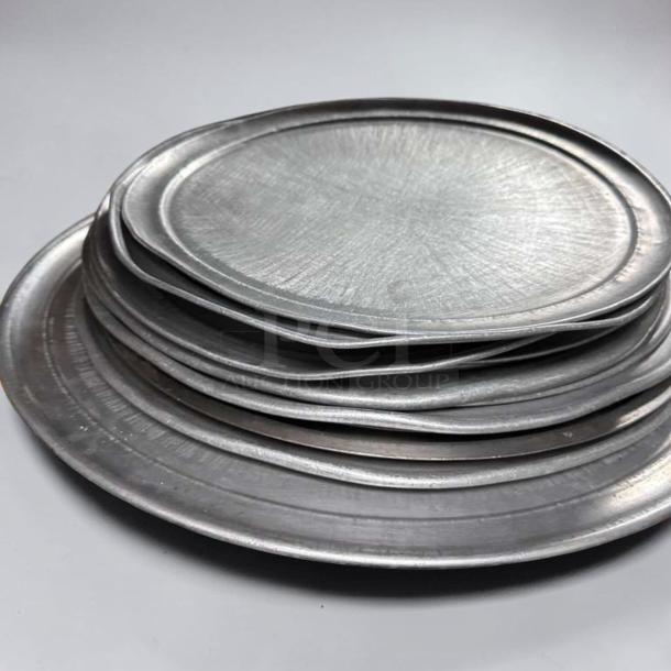 Stack of commercial aluminum round pizza pans in various sizes, heavy-duty, restaurant grade, unbranded, in superior condition.