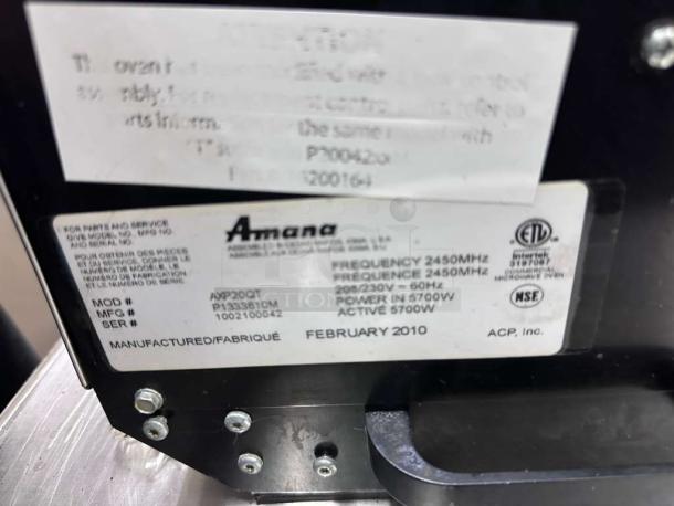 Amana AXP20 high-speed microwave convection oven label, showing model, frequency, power specs, and manufacture date.