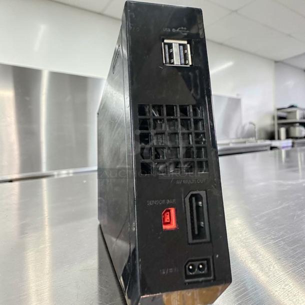 Black Nintendo Wii RVL-001 console, excellent condition, region-free, GameCube compatible, fully tested, rear USB and AV ports visible.