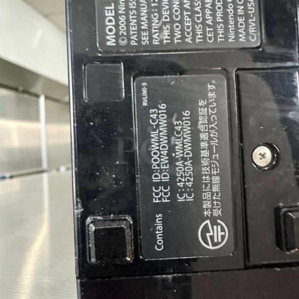 Nintendo Wii RVL-001 Black Console with labels visible; indicates model, FCC ID, and region-free capability. Excellent condition.