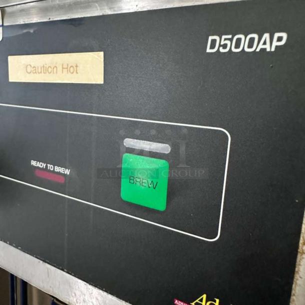 Wilbur Curtis D500GT12A000 coffee brewer, black control panel with "Caution Hot" label, brew button visible.