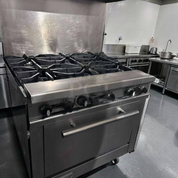 Exceptional Connerton CN36-6_LP gas range with 6 burners, oven base, and stainless steel. Tested and operational.