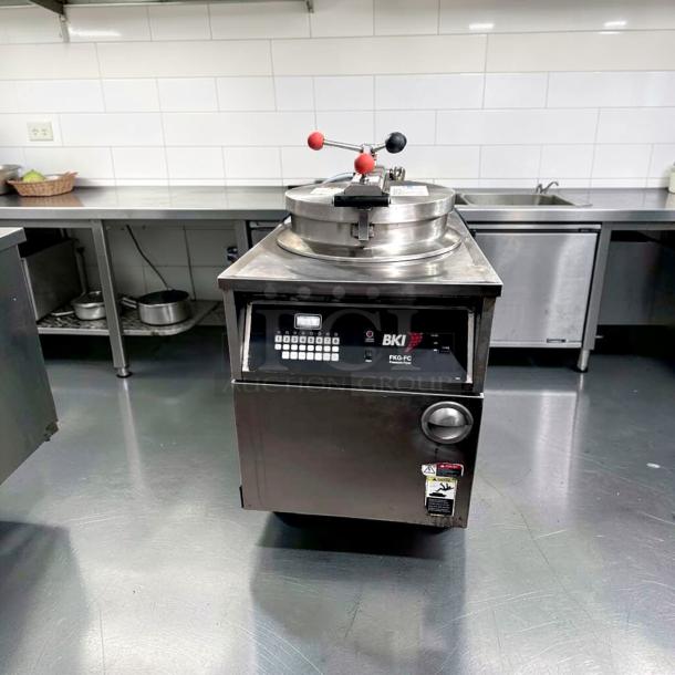 BKI FKG-FC commercial gas pressure fryer, 24" wide, 18 lb capacity, 70,000 BTU, stainless steel, fully tested and operational.