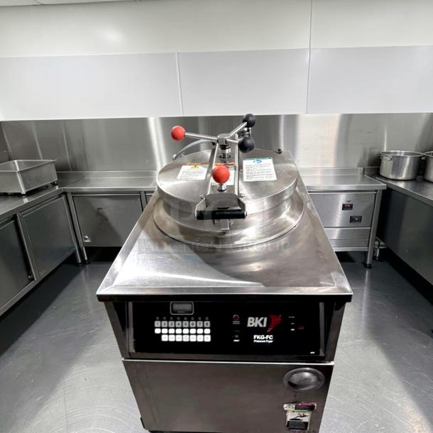 Prime condition BKI FKG-FC commercial gas pressure fryer, 24" wide, 18 lb capacity, 70,000 BTU, stainless steel, fully tested.