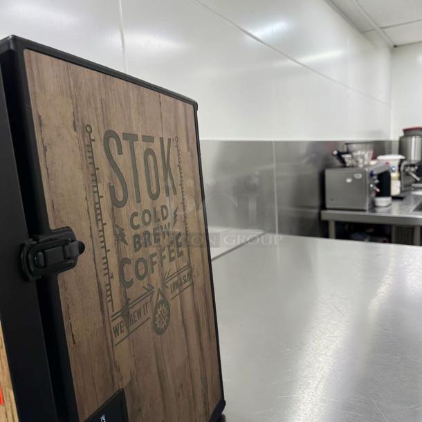 CreaMiser Model 230 Cold Brew Dispenser with dual taps, wood panel design, labeled "STŌK Cold Brew Coffee", in exceptional condition.