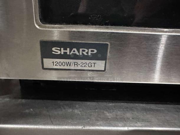 Sharp R22GTF commercial microwave, 1,200W, stainless steel, 20 programmable memories, superior condition, model label visible.