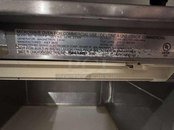 Sharp R22GTF commercial microwave oven, 1,200W, stainless steel, 20 programmable memories, Sharp label visible, fully operational.