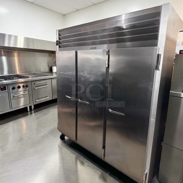 Traulsen G31310 reach-in freezer, 77" stainless steel, three solid doors, excellent condition, 208/115V, commercial use.