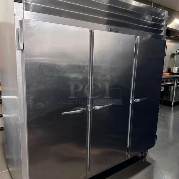 Traulsen G31310 three-section stainless steel reach-in freezer, 77", solid doors, excellent condition, 208/115V, tested.