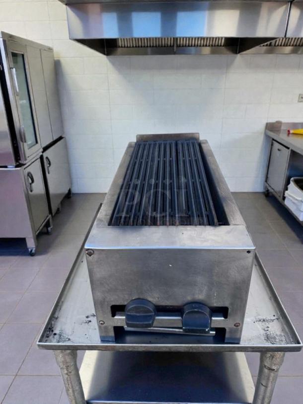 Commercial Grade 24" gas charbroiler, stainless steel, outstanding condition, fully operational, with control knobs.