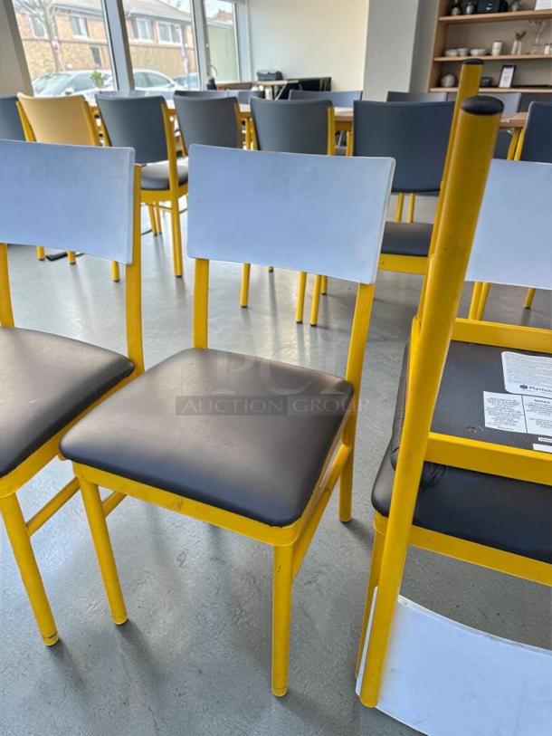 Commercial restaurant dining chairs with upholstered seat and back, heavy-duty yellow metal frame, inspected, ready for use.