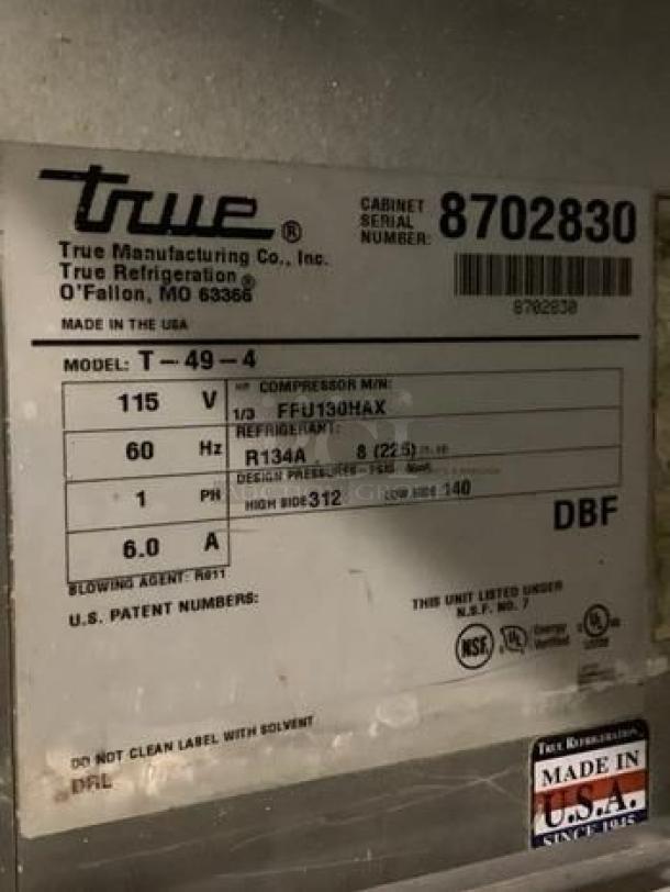 Label on True T-49-4 commercial refrigerator showing model, voltage, refrigerant type, and "Made in USA" marking.