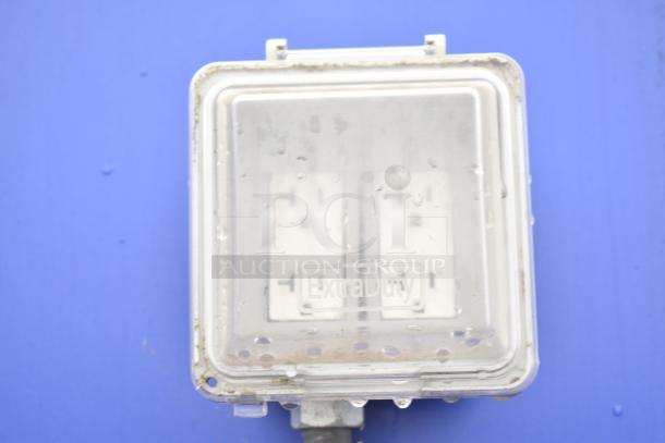 A clear electrical outlet cover labeled "Extra Duty" on a blue background.