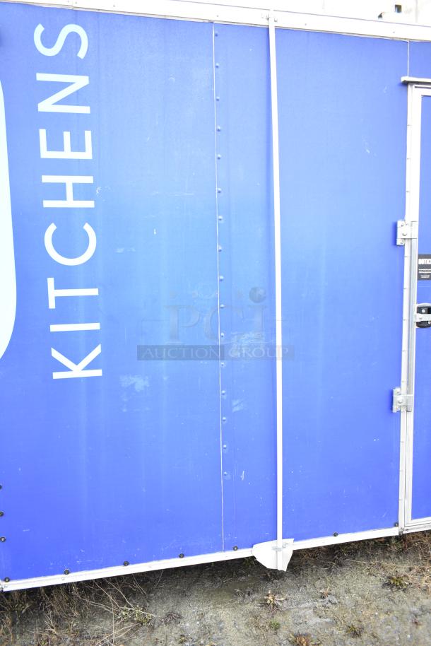 Fully equipped commercial mobile kitchen trailer, blue exterior, features CaptiveAire hood, Pitco propane fryers, refrigeration.